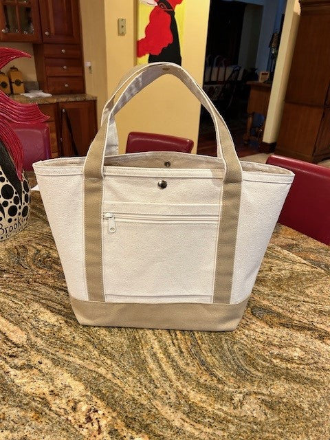 The Semen Tanks - Select Genetics Totes for Everyday Use in beige with accent, available with 18 or 24 inch straps, features tan handles, white trim, a front zippered pocket, and top snap closure—perfect for organizing your essentials.
