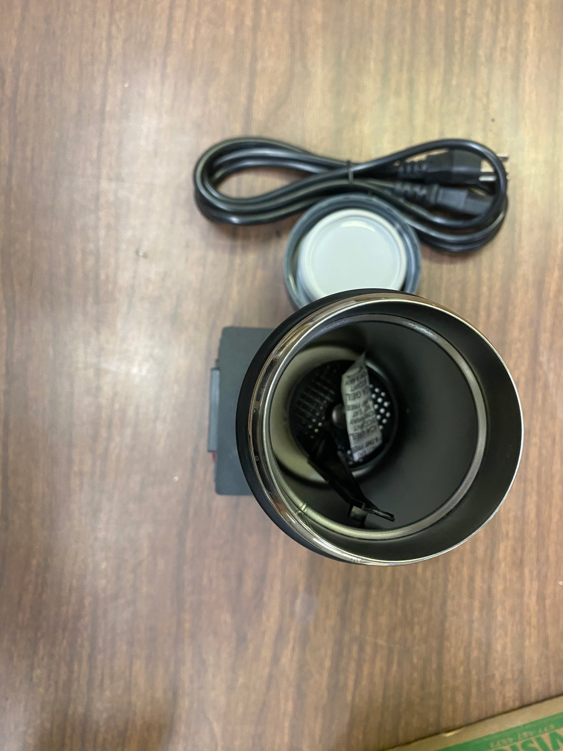 A Semen Tanks - Select Genetics Digital Semen Thawing / Embryo Thawing Unit - 12V (1023022) with lid off sits on a wooden surface, power cable and lid above. Designed for precise warming in embryo or semen thawing applications.