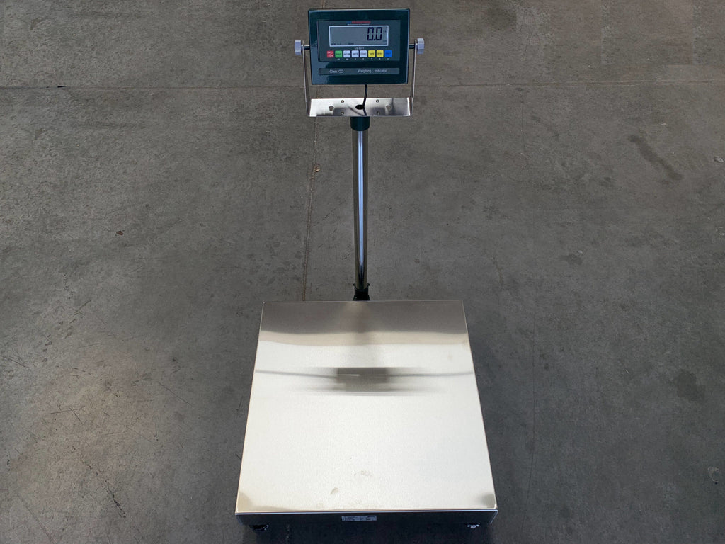 The Semen Tanks - Select Genetics Bench Cryo-Alert Scale 24"x24" with US-6011 Indicator and Stacklight (90 lbs) features a stainless steel platform and vertical display, standing on a concrete floor.