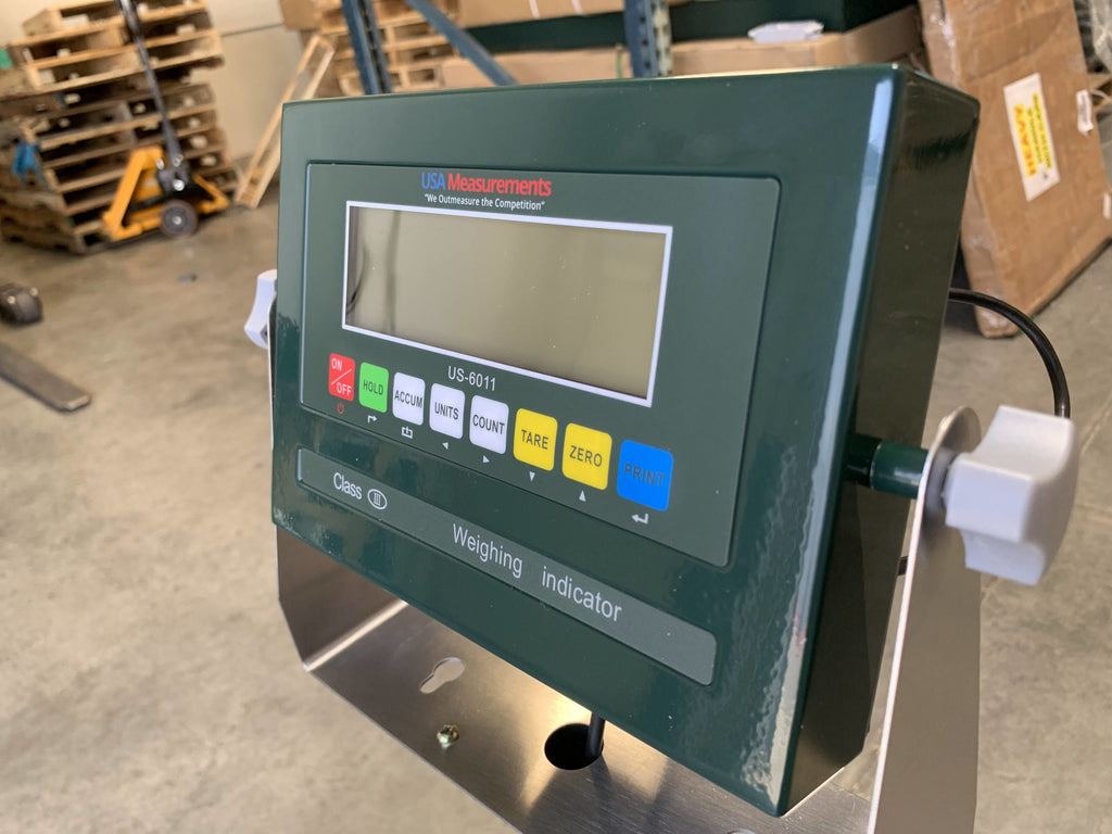 A close-up of the Semen Tanks - Select Genetics Bench Cryo-Alert Scale 24"x24" (90 lbs) with US-6011 Indicator featuring HOLD, UNITS, COUNT, TARE, ZERO, PRINT buttons and stacklight near a tank scale in an industrial setting.