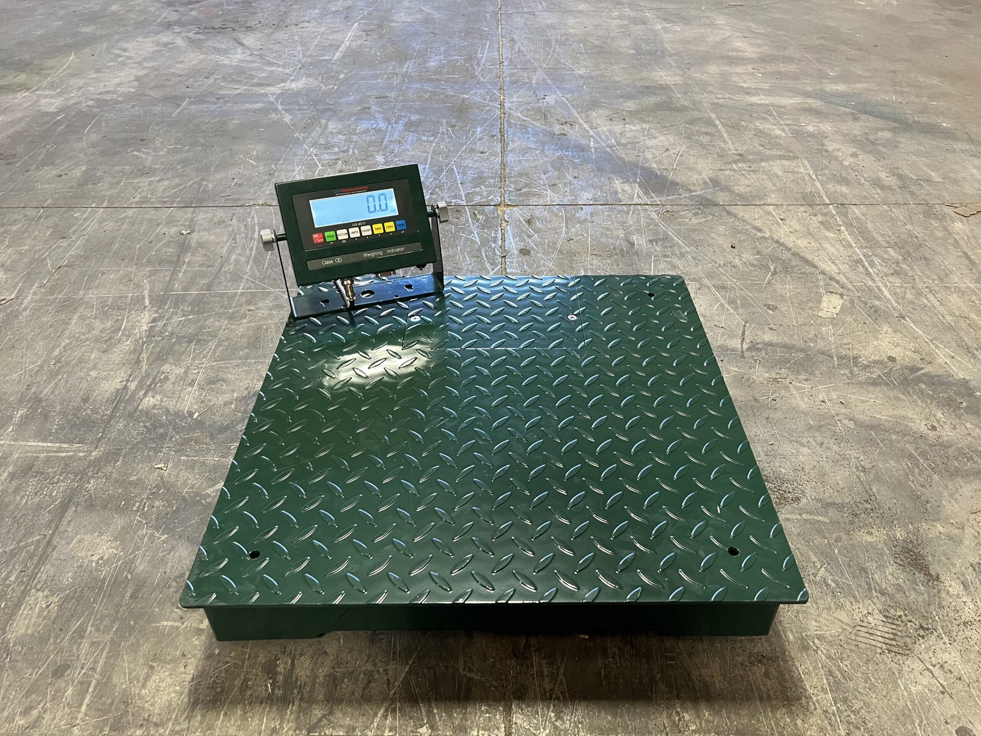 The CRYO-ALERT Floor Scale by Semen Tanks - Select Genetics, weighing 110 lbs, features a digital weight indicator and stack light. Its textured surface makes it ideal for precise embryo tank monitoring in warehouse settings.