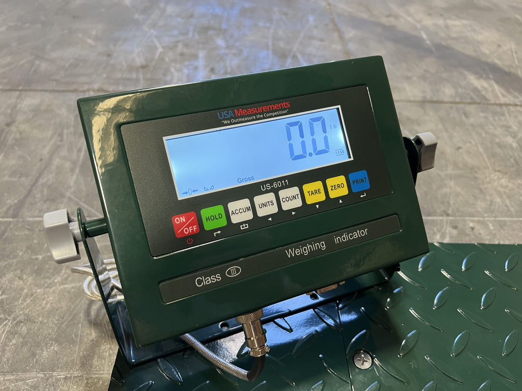 A close-up of the CRYO-ALERT FLOOR SCALE by Semen Tanks - Select Genetics, a 110 lb weight indicator with stack light and colored function buttons, shown displaying 0.0 lb on a green metal platform.