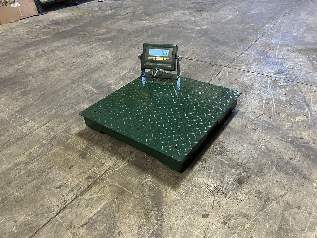 A Semen Tanks - Select Genetics CRYO-ALERT Floor Scale with weight indicator and stack light, weighing 110 lbs, features a green diamond plate surface and digital display, positioned on a worn concrete warehouse floor near the image’s center.