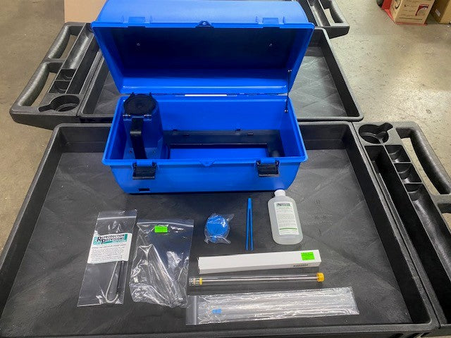 An RR Goat AI kit with Electric Thaw Unit sits open in its case on a black cart, containing items like the CITO digital thaw, tweezers, a thermometer, straw cutter, LED light, Priority Care supplies, speculum, goat gun, and sheaths.