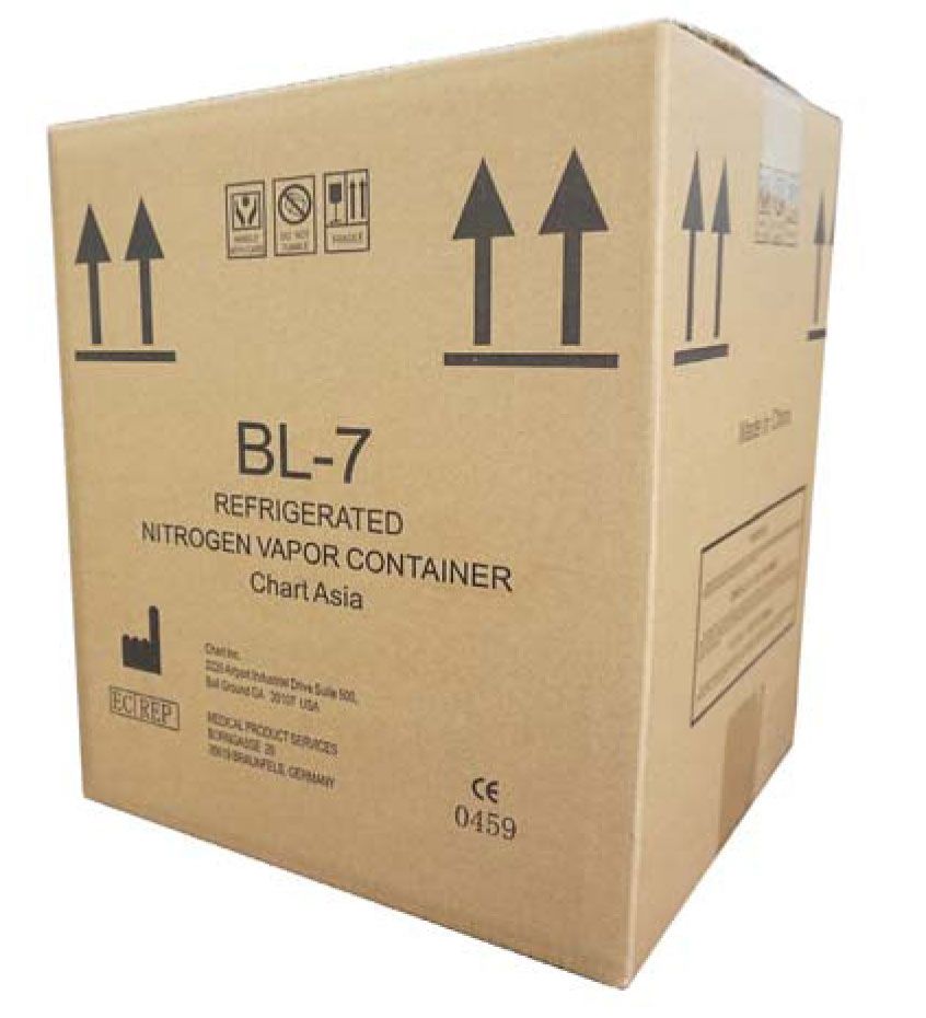 A cardboard shipping box labeled MVE BL7 Cryocube - One Year Vacuum Warranty, Chart/MVE, with caution symbols and black up arrows, designed for cryogenic shipping of biological samples.